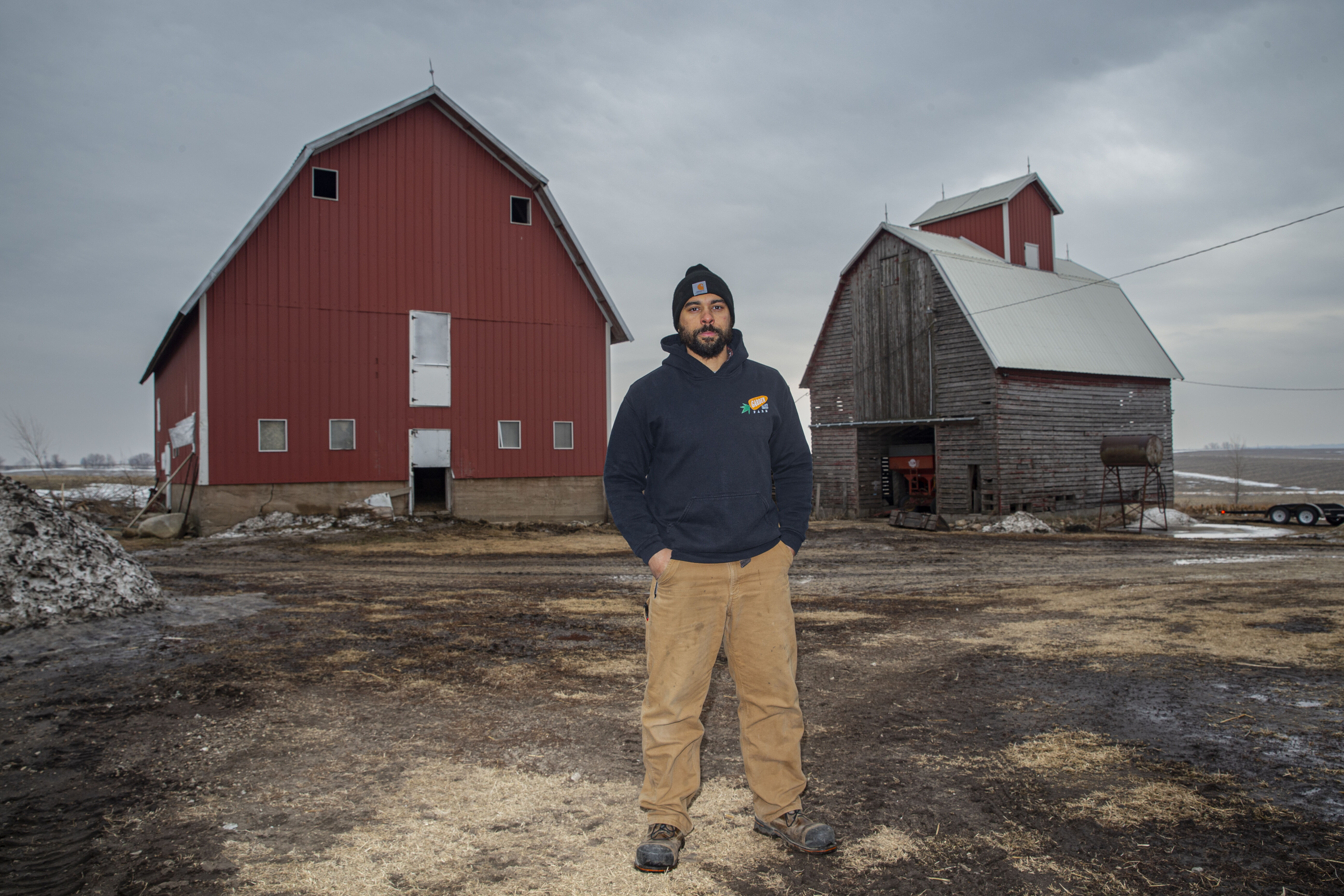 T.D. Holub stands for a portrait at his Farm near Coggon on Feb. 16. Holub uses high-tunnel greenhouses to extend the vegetable growing season.
