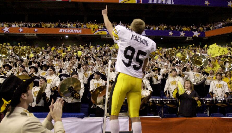 Iowa kicker Nate Kaeding (95) celebrates with the Hawkeye marching band and fans after Iowa defeated Texas Tech 19-16 in the Alamo Bowl on Dec. 29, 2001. Kaeding kicked four field goals.